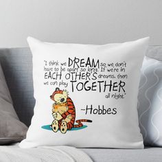 a white pillow with a cartoon tiger sitting on it's back and the words dream written