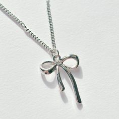 Stainless steel bow necklace.  16 inches in length. Matching navel piercing and earrings available on my page. An amazing gift idea for a friend, family member, or girlfriend 🦭 This is a handmade item so please treat me with care, this includes drying after wet and storing appropriately. All items on my page are BRAND NEW. If you have any questions feel free to send a message! 🫶🏻 Items are posted via RoyalMail. UK Shipping expected estimation 2-5 working days, international shipping expected Gift Idea Friend, Coquette Ribbon, Bow Charm, Bow Necklace, Navel Piercing, Bow Ribbon, Charm Pendant Necklace, Necklace Minimalist, Pretty Stuff