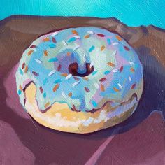 a painting of a donut with sprinkles on it sitting on a table