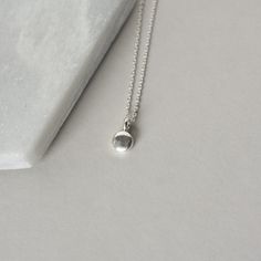 A dainty minimalist accessory that's perfect for everyday wear! This necklace features a tiny sterling silver pebble charm paired with sterling silver cable chain. The small disc is 5mm wide and about 2mm thick and it has a sleek bright polish that gives the necklace a modern feel. The simple design makes this a versatile accessory and it looks chic alone or layered with others. The necklace is fastened with a sterling silver spring ring clasp and you can choose your desired length from the drop-down menu above. You can find lots more minimalist necklaces here: www.etsy.com/ca/shop/juliegarland/search?search_query=minimalist+necklace And to return to the store: www.etsy.com/ca/shop/juliegarland SAVE 10% on your Etsy purchase today when you become an insider: https://www.juliegarlandjewelry Everyday Sterling Silver Charm Necklace With Moon Charm, Sterling Silver Moon Charm Necklace For Everyday, Simple Sterling Silver Charm Necklace For Everyday, Dainty Small Charm Necklace For Everyday, Simple Everyday Sterling Silver Charm Necklace, Simple Sterling Silver Necklace For Everyday, Minimalist Tiny Charm Necklaces For Everyday, Simple Round Pendant Charm Necklace For Everyday, Simple Sterling Silver Everyday Necklace