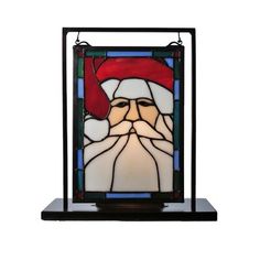 a stained glass window with santa claus's face on it and a red hat