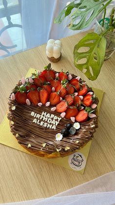 a birthday cake with strawberries on top