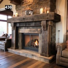 a living room filled with furniture and a fire place next to a couch on top of a hard wood floor