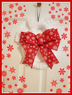 a red and white wreath with snowflakes on it