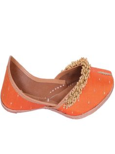 Orange fabric juttis with Gold tiny ghunghroos add a touch of flirty fun to your ensemble with their handiwork and floral pattern. Wear it with a purple and gold sharara set to a friend’s wedding. Color: Orange Fabric: Upper- Silk Embroidered fabric with gold tiny ghungroos, Inner - leather lining cushion for extra comfort & pure leather sole Note: Available in other colors Heel type - Flat The product will be shipped within 20-25 days of the order placed Care intructions - Keep in dust bag, dry Gold Sharara, Sharara Set, Gold Silk, Orange Fabric, Embroidered Fabric, Wedding Color, Orange Gold, Heel Type, Embroidered Silk