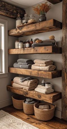 the shelves in this bathroom are made out of wood and have baskets for towels on them