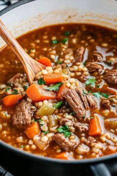 a pot filled with beef and barley soup