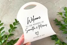 someone holding up a white door hanger with the words welcome to the wedding of sampeta and mario