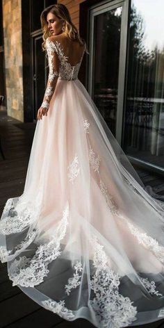 a woman in a wedding dress standing on a porch with her back to the camera