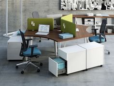 an office desk with two laptops on it and several chairs in front of it