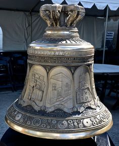 a large metal bell sitting on top of a table