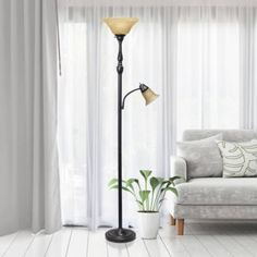 a living room scene with focus on the floor lamp and sofa in the background,