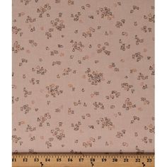 a ruler is next to a fabric with small flowers on it