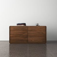 a wooden dresser sitting on top of a tiled floor next to a white wall and window