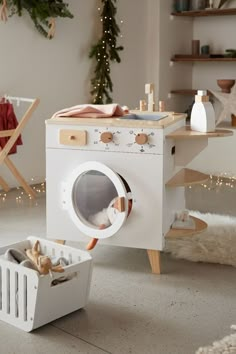 a white washer sitting in front of a christmas tree