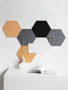 a white table topped with lots of different colored hexagonals on top of it