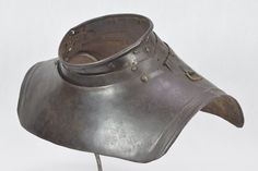 an old metal helmet is shown on a white background