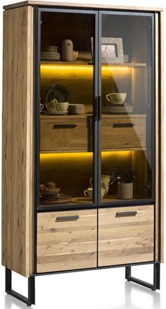 a large wooden cabinet with glass doors and lights on the bottom, in front of a white background