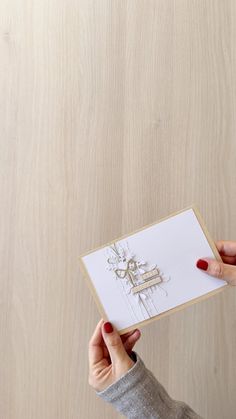 a person holding up a card with a drawing on it