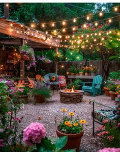 an outdoor patio with lots of flowers and lights strung over the fire pit, surrounded by potted plants