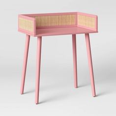 a pink table with wicker top and legs