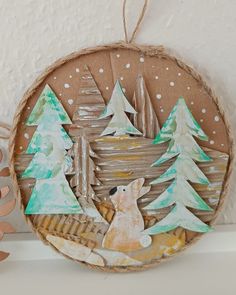 an ornament with a bear and trees on it