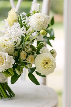 a bouquet of flowers sitting on top of a white chair