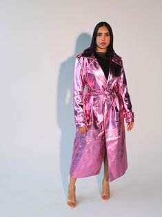 Make a bold statement with this stunning Metallic Pink Vegan Leather Trench Coat. Crafted from cruelty-free materials, this women's long trench coat is the ultimate blend of edgy style and sophistication. Its high-shine metallic finish makes it perfect for festivals, rave wear, or any occasion where you want to stand out. This double-breasted trench coat features classic lapels, a front button fastening, and a self-tie belt for a flattering silhouette. The relaxed fit, long sleeves with buckle-fastened cuffs, and the lightweight feel make this an ideal layering piece for any season. Key Features: -Fabric: SHELL: 50% Viscose, 45% Polyurethane. Lining: 100% Polyester. Durable, cruelty-free vegan leather. -Double-breasted lapels & button fastening: Timeless trench coat style with a modern twi Pink Vinyl Trench Coat, Womens Long Coat, Trench Coats Women Long, Pink Trench Coat, Trench Coat Style, Long Coat Women, Coat Style, Leather Trench, Double Breasted Trench Coat