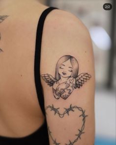 a woman with a tattoo on her arm holding a teddy bear