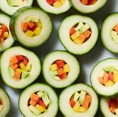 cucumbers with cut up pieces of fruit on them