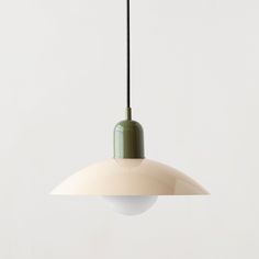 a white and green light hanging from a ceiling fixture with a black cord attached to it