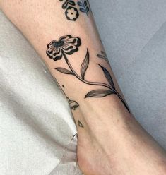 a person with a flower tattoo on their foot