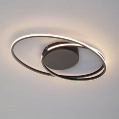 an overhead view of a circular light fixture in a white room with the lights turned on