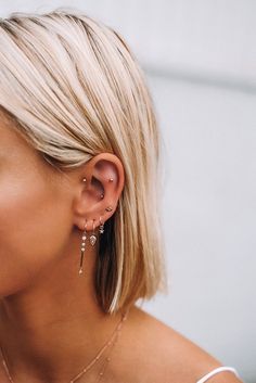 a woman with blonde hair wearing ear piercings