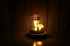 an illuminated mushroom lamp sitting on top of a table