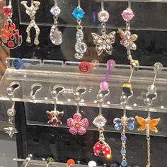 a display case filled with lots of different colored earrings