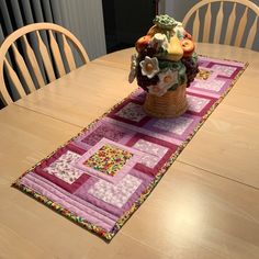 a table runner with a basket of fruit on it