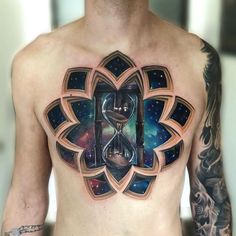 a man's chest with an hourglass tattoo on it