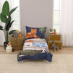 a child's bed with an animal themed comforter