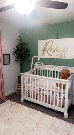 a baby's room with a white crib and pink curtains