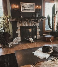 a living room filled with furniture and a fire place in the middle of a wooden floor