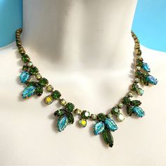 Vintage Regency Green & Ab Rhinestones Blue Molded Glass Leaves Iridescent Necklace Signed Regency. Stunning Necklace Measures 16" With Hook Clasp. Beautiful Rhinestones And Molded Glass Leaves Are All Prong Set. Noted To Be Missing One Green Rhinestone As Shown In Photos, Right Before The Hook Clasp. Could Easily Be Replaced If Desired. Beautiful Vintage Hard-To-Find Green Rhinestone Stunning Regency Necklace. #5 Regency Necklace, Regency Jewelry, Iridescent Necklace, Leaves Necklace, Glass Molds, Hook Clasp, Leaf Necklace, Stunning Necklace, Prong Setting