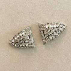 Trifari is known for its excellence in design and quality. It is very unusual to find Trifari dress clips.  This set is magnificent and in really good condition. Elegant Clip-on Brooches For Formal Occasions, Elegant Embellished Evening Brooch, Glamorous Rhinestone Clip-on Earrings For Formal Events, Formal Crystal Embellished Brooches, Glamorous Rhinestone Clip-on Earrings For Formal Occasions, Glamorous Formal Clip-on Earrings With Rhinestones, Elegant Clip-on Brooches For Evening, Vintage Crystal Embellished Brooches For Formal Events, Vintage Diamond Accented Brooches For Evening