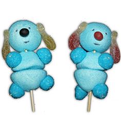 two lollipops shaped like dogs with ears and tail sitting on top of each other