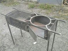 an outdoor grill is sitting on the ground