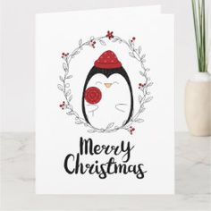 a christmas card with an image of a penguin wearing a red hat and the words merry christmas