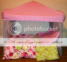 a child's bed with pink and white polka dots