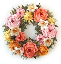 a wreath made out of paper flowers and leaves