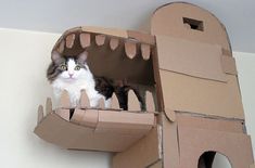 a cat is sitting in a cardboard castle