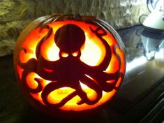 an octopus carved into a pumpkin on a table